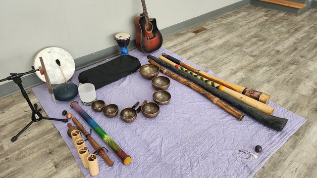 Singing bowls arranged in a curve for a sound bath